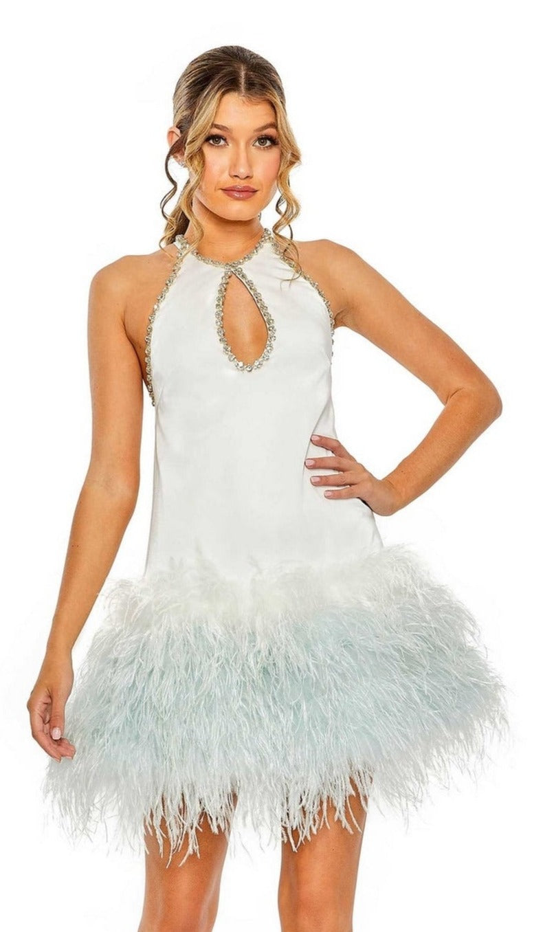 A woman in the Short Homecoming Dress 11437 by Mac Duggal, featuring a white feather trim, jeweled halter neckline, and sleeveless design, stands against a plain background.